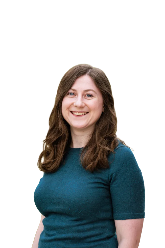 Smiling woman with long brown hair wearing a teal shirt