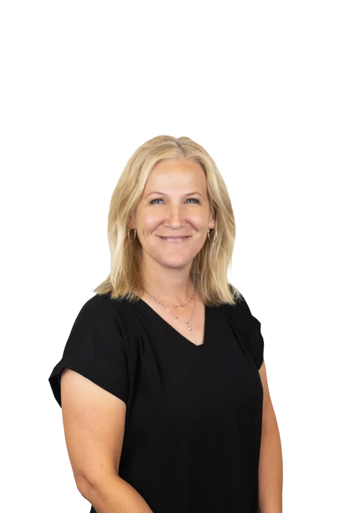 Smiling blonde woman wearing a black top and layered necklaces