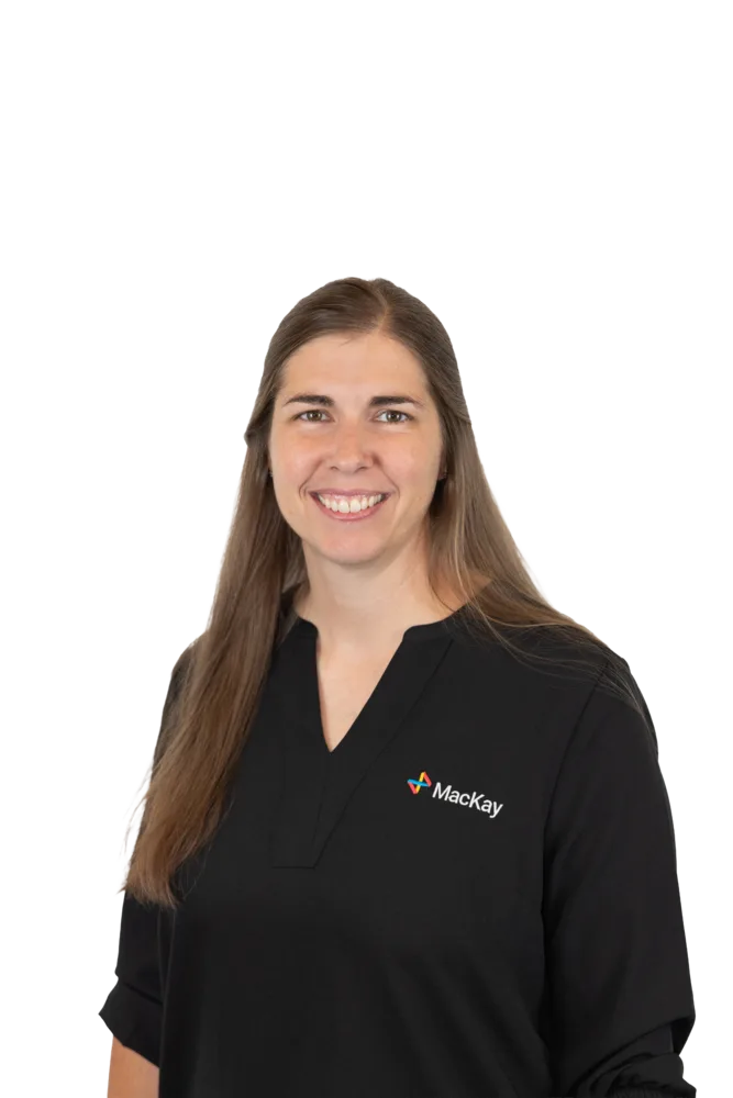 Smiling woman with long brown hair wearing a black MacKay-branded shirt