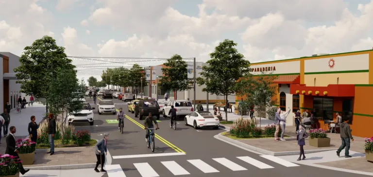 Rendering of a lively, tree-lined commercial street with cars sharing the road with cyclists, pedestrians using a striped crosswalk, string lights overhead, and outdoor seating by a panadería.