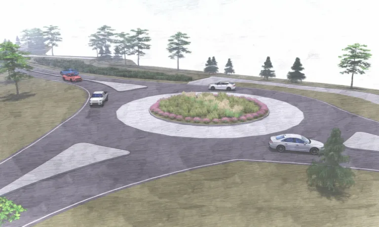 Architectural rendering of a single-lane roundabout with a landscaped central island of grasses and pink flowers, several cars navigating the circle, and trees bordering the roadway.