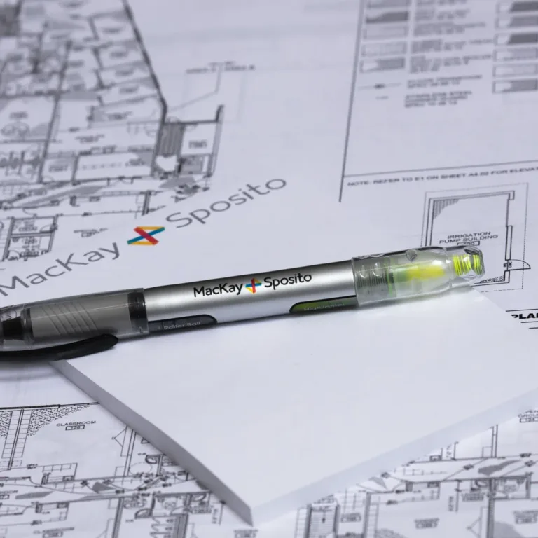 Historical photo of a MacKay–branded pen/highlighter on a notepad atop architectural blueprints, with the MacKay logo visible in the background.
