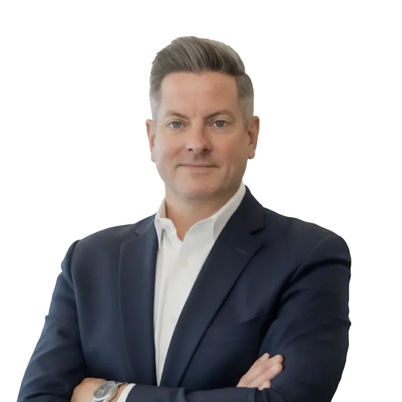 Professional headshot of a man in a navy suit and white shirt with his arms crossed