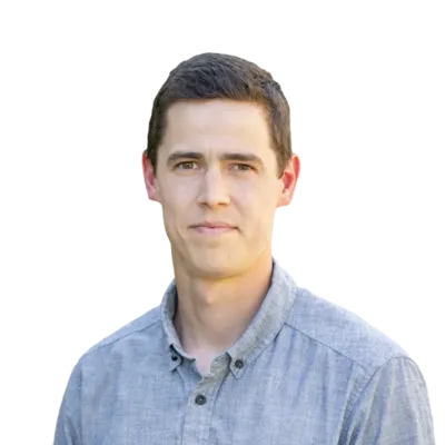 Man wearing a light blue button-down shirt, facing the camera