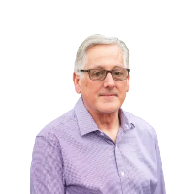 Gray-haired man wearing glasses and a purple button-down shirt