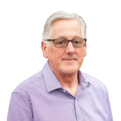 Gray-haired man wearing glasses and a purple button-down shirt