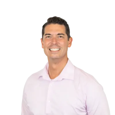 Smiling man wearing a light pink button-down shirt