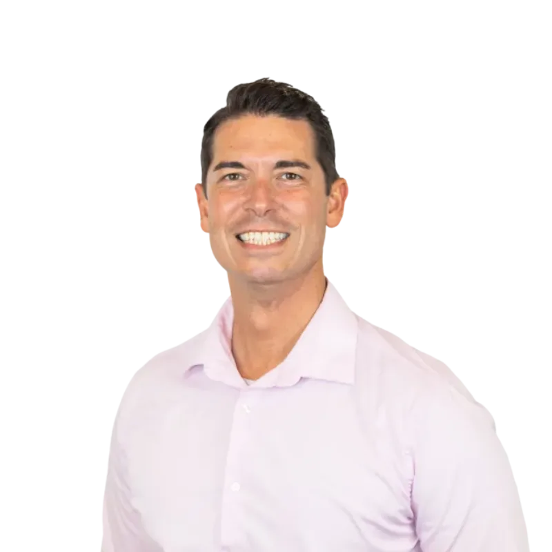 Smiling man wearing a light pink button-down shirt