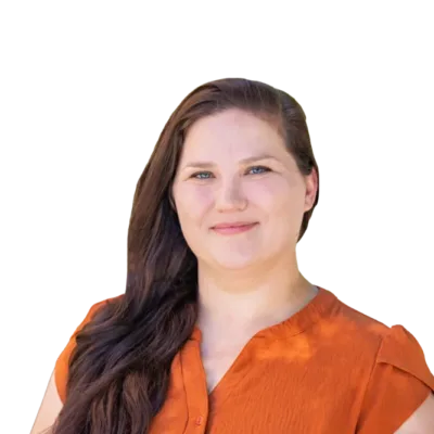 Portrait of a smiling woman with long brown hair wearing an orange blouse