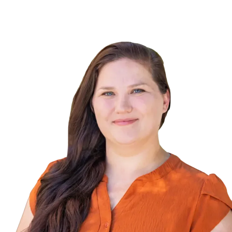 Portrait of a smiling woman with long brown hair wearing an orange blouse