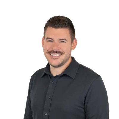 Smiling man with short dark hair and a mustache wearing a black button-up shirt