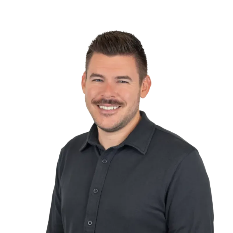 Smiling man with short dark hair and a mustache wearing a black button-up shirt