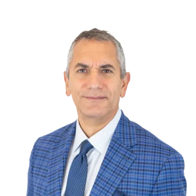 Man wearing a blue plaid suit, white shirt, and patterned tie
