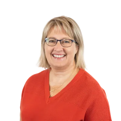 Smiling blonde woman wearing glasses and a red top
