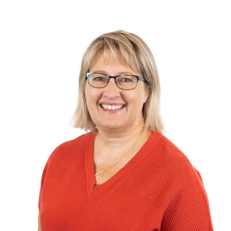 Smiling blonde woman wearing glasses and a red top