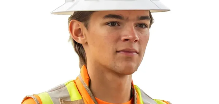 Construction worker wearing a white MacKay hard hat and high-visibility orange safety vest